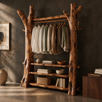 Corner detail of open wardrobe with tree trunk posts, a hanging rail and three plank shelves beside wood, brass and linen samples