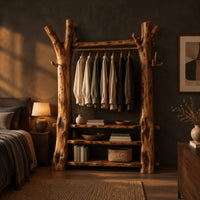 Open wardrobe with tree trunk posts, a hanging rail and three plank shelves in a dark bedroom at golden hour