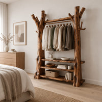 Open wardrobe with tree trunk posts, a hanging rail and three plank shelves in a Scandinavian bedroom with white walls