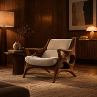 Openwork wooden lounge chair with hollowed arms and splayed legs in an evening living room with walnut wall paneling