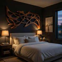 Hand carved organic openwork wooden wall sculpture above a bed in a dusk lit bedroom