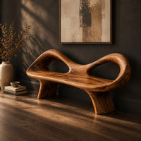 Organic wooden bench with a raised rim, two oval cutouts and tapered legs, three-quarter view showing the grain
