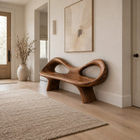 Organic wooden bench with a raised rim, two oval cutouts and tapered legs in a Scandinavian entryway with white walls