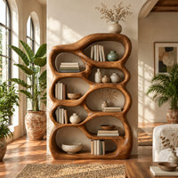 Open bookshelf with rounded pebble shaped compartments in a bright living room with arched windows and plants