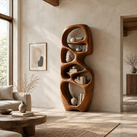 Tall organic wooden bookshelf with uneven oval shelf pockets in a bright open plan living room