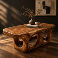 Coffee table with round porthole openings in a solid base, three-quarter view showing the grain