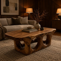 Coffee table with round porthole openings in a solid base in an evening living room with walnut wall paneling