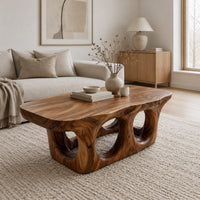 Coffee table with round porthole openings in a solid base in a Scandinavian living room with white walls