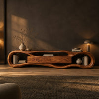 Organic loop shaped media stand with three center panels and open book nooks in a dark living room at golden hour
