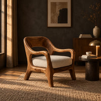 Open back chair with curved crest rail and splayed legs in a dark living room at golden hour