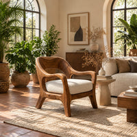 Open back chair with curved crest rail and splayed legs in a bright living room with arched windows and plants