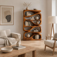 Stacked bookshelf with flowing teardrop shaped openings in a Scandinavian living room with white walls