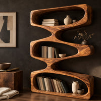 Corner detail of bookshelf of three stacked open loops with pinched waists beside wood, brass and linen samples