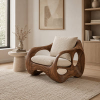 Wraparound lounge chair with open loop sides and arched base in a Scandinavian living room with white walls