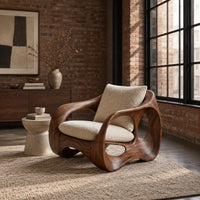 Wraparound lounge chair with open loop sides and arched base in an industrial loft living room with exposed brick