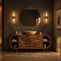 Oval vanity cabinet on tapered legs with carved wave doors and open end shelves in a dark bathroom at golden hour