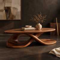 Corner detail of oval coffee table on a twisting ribbon base with an open loop beside wood, brass and linen samples