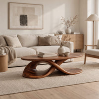 Oval coffee table on a twisting ribbon base with an open loop in a Scandinavian living room with white walls