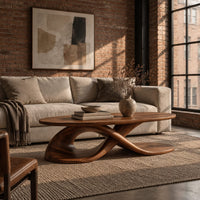 Oval coffee table on a twisting ribbon base with an open loop in an industrial loft living room with exposed brick