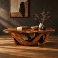 Oval coffee table on an interlaced base with open loops in a dark studio against a charcoal plaster wall