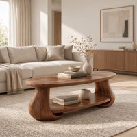 Oval coffee table with swelling tulip shaped legs and a lower shelf in a Scandinavian living room with white walls