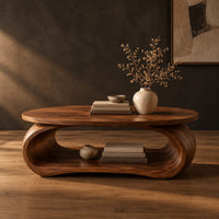 Oval coffee table on a bent loop base with a low shelf inside in a dark studio against a charcoal plaster wall
