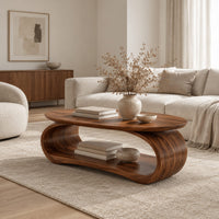 Oval coffee table on a bent loop base with a low shelf inside in a Scandinavian living room with white walls