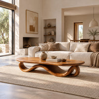 Oval coffee table with a flowing wave ribbon base in a bright open plan living room