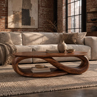 Oval coffee table with an infinity loop base and lower shelf in an industrial loft living room with exposed brick