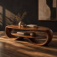 Oval coffee table with a looping wood frame and a lower shelf, three-quarter view showing the grain