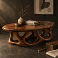 Corner detail of oval coffee table on a base of interlocking open arches beside wood, brass and linen samples
