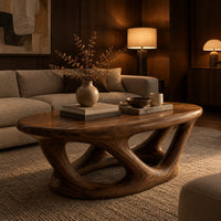 Oval coffee table on interlocking looped wooden legs with a thick top in an evening living room with walnut wall paneling