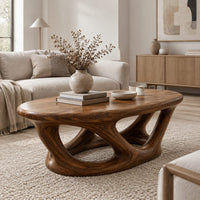 Oval coffee table on interlocking looped wooden legs with a thick top in a Scandinavian living room with white walls