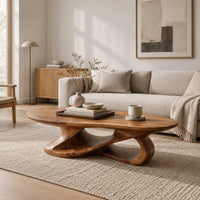 Oval coffee table on a looping ribbon base with open gaps in a Scandinavian living room with white walls