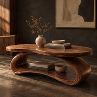 Corner detail of oval wood coffee table on a looping ribbon base with an open lower shelf beside wood, brass and linen samples