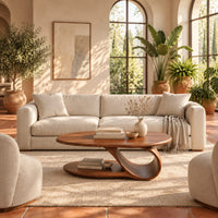 Oval coffee table with a low oval shelf and a single scroll support in a bright living room with arched windows and plants