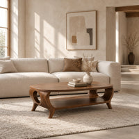 Oval coffee table with a lower shelf and flared legs with circular cutouts in a bright open plan living room