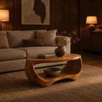 Oval coffee table with a sculpted body and open lower shelf in an evening living room with walnut wall paneling