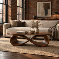 Oval coffee table with a sculpted infinity loop base in an industrial loft living room with exposed brick