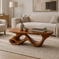 Oval coffee table on a twisting ribbon base with open loops in a Scandinavian living room with white walls