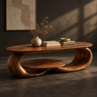 Corner detail of oval coffee table on two curled legs with a small oval shelf below beside wood, brass and linen samples