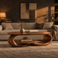 Oval coffee table on two curled legs with a small oval shelf below in a dark living room at golden hour
