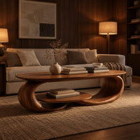 Oval coffee table on two curled legs with a small oval shelf below in an evening living room with walnut wall paneling