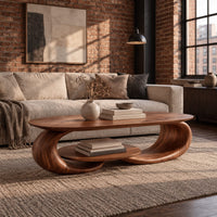Oval coffee table on two curled legs with a small oval shelf below in an industrial loft living room with exposed brick