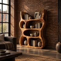 Chunky wood bookshelf with oval cubbies and wavy sides in an industrial loft living room with exposed brick