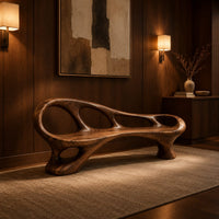 Long wooden bench with oval cutouts along the back rail and a flowing frame in an evening entryway with walnut wall paneling