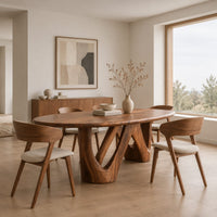 Oval dining table with a thick top and sculpted zigzag supports in a Scandinavian dining room with white walls