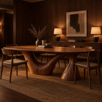 Oval dining table on a sweeping arm base and a tall cone column in an evening dining room with walnut wall paneling
