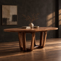 Oval dining table with sculpted arched legs joined by a low floor loop, three-quarter view showing the grain