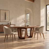 Oval dining table with sculpted arched legs joined by a low floor loop in a bright open plan dining room